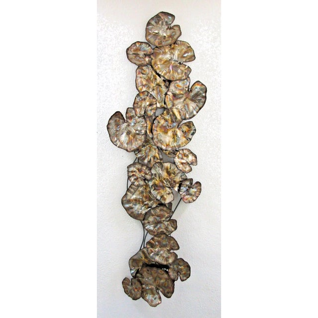 The Vintage Torch Cut Brass Lily Pad 67 inch Wall Sculpture, attributed to Curtis Jere, is a large and handmade piece of...