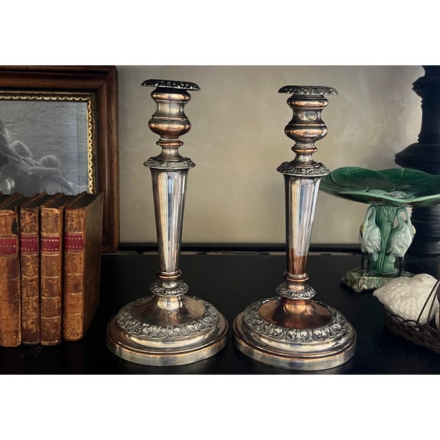 Antique candlesticks made in England in 1815. One candle has had a 1948 shilling inserted inside.