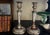 Antique candlesticks made in England in 1815. One candle has had a 1948 shilling inserted inside.