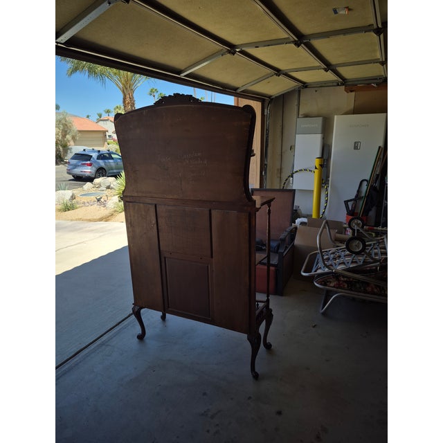 This piece of furniture is an antique Victorian mahogany étagère with a central curio cabinet (sometimes called a...