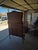 This piece of furniture is an antique Victorian mahogany étagère with a central curio cabinet (sometimes called a...