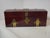 Burgundy lacquered wooden box with metal studs and a padlock. Shaped like an antique chest in a neo-medieval style. Wooden...