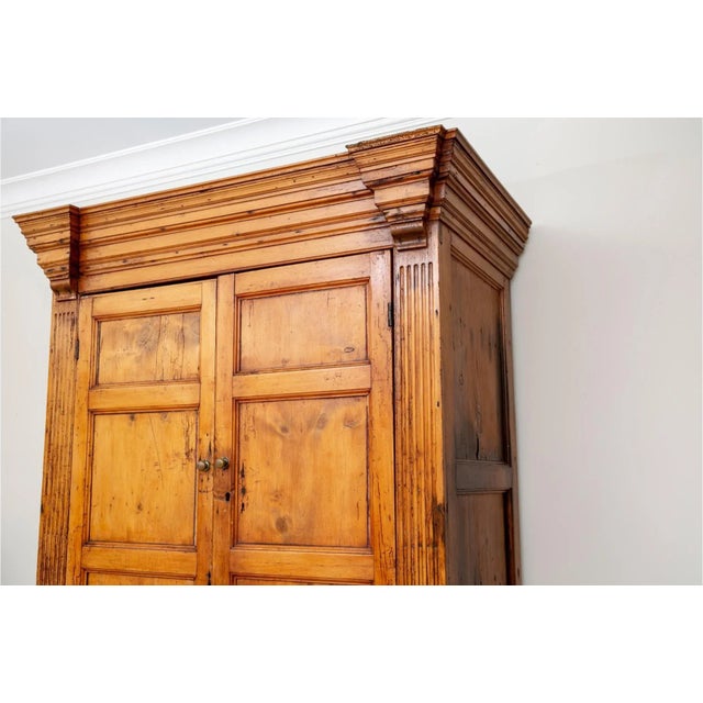 An imposing antique pine cabinet with rich caramel hues, fine graining, wonderful patina and brass hardware. The cabinet...