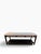 A handsome contemporary upholstered bench by Arhaus, featuring a streamlined dark-finished wood frame, neutral upholstered...