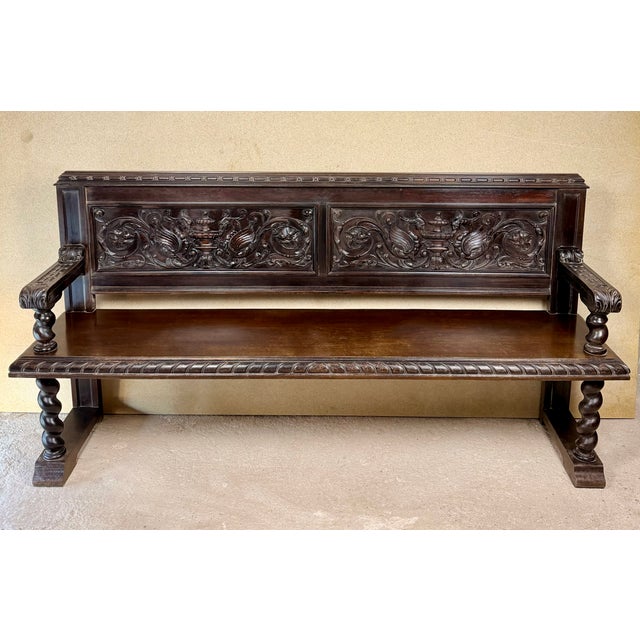 Impressive Spanish bench crafted from wood, featuring richly carved decoration and a strong traditional character. The...