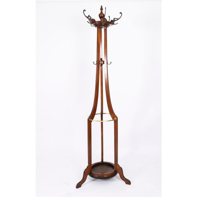 An excellent antique free standing oak and brass coat / hat / stick hallstand, circa 1880 in date. The upper part centred...