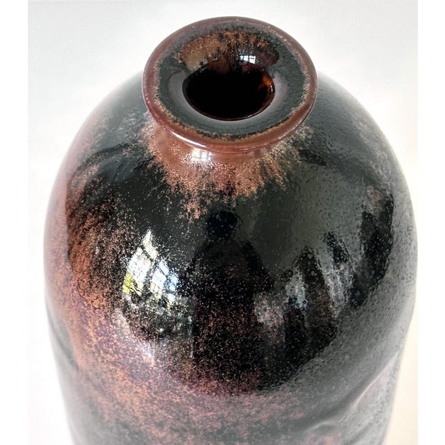 An early ceramic vase of cylinder form by potter Brother Thomas Bezanson (1929-2007). The minimalistic silouette that...