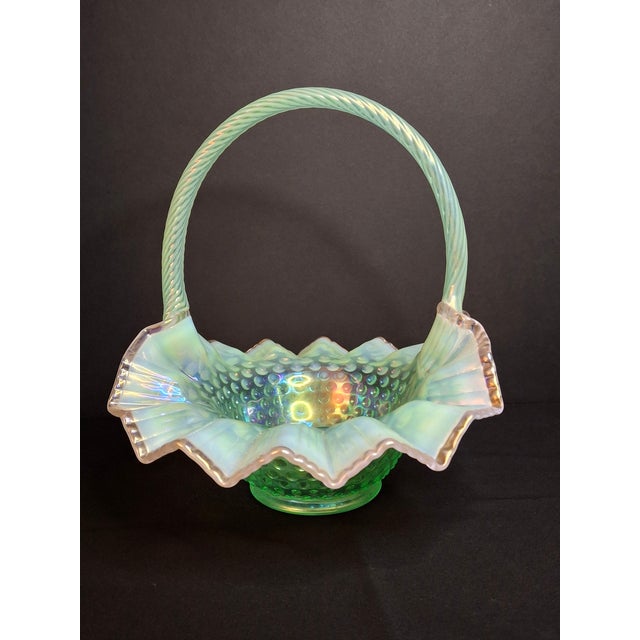 This large, vintage Fenton Art Glass Bride’s Basket is pressed in the iconic Hobnail pattern using a vibrant translucent...
