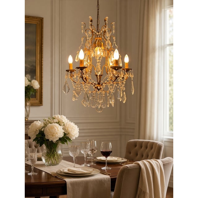 An elegant italian chandelier dating from the 1950s, featuring an ornate gilded florentine-style metal frame adorned with...