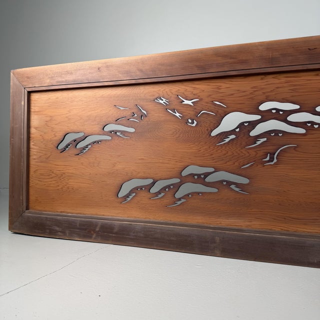 This long, horizontal ranma panel is carved in openwork technique (sukashibori) and depicts a serene scene of cranes in...