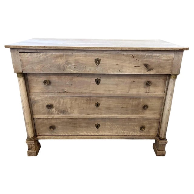 Empire chest of drawers hand-made in Italy in the early 1800s using walnut. The dresser features four inset drawers, all...