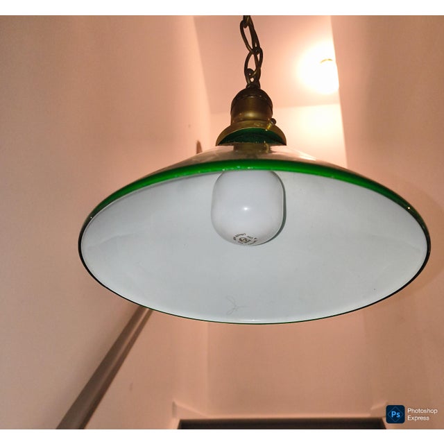 green enamel cone shaped hanging lamp. brass fittings and chain . shade is 10" across at base