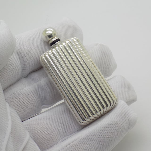 This vintage silver vanity object depicts a miniature perfume bottle, crafted as a usable scent flask, dressing table...