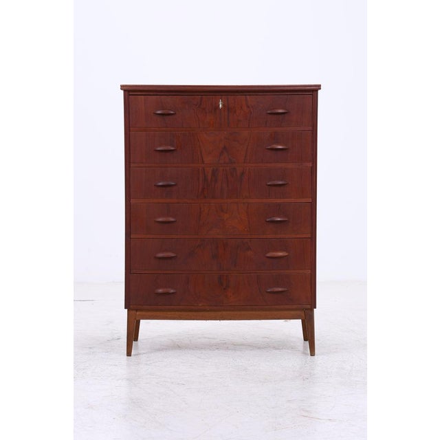 Vintage tallboy wardrobe in Scandinavian design from the 1960s. Six spacious drawers offer plenty of storage space, while...