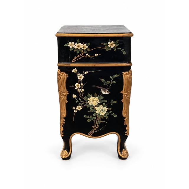 Elegant Chinoiserie-style bombe chest featuring a glossy black lacquer finish with delicate floral, flowering-branch, and...