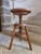 A vintage French stool from the 1950s, made of solid beechwood. This charming piece features a screw-adjustable seat...