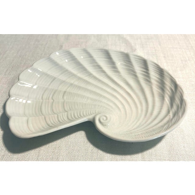 Mid-century style decorative porcelain shell plate by Andrea by Sadek, featuring a sculpted shell-inspired form with hand-...