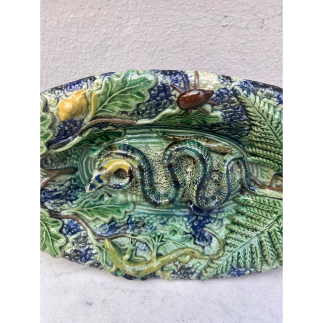 19th Century Majolica Palissy Snake Wall Platter On a blue background, a snake on the center decorated with a...