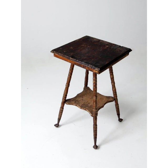 Late 19th century antique side table featuring carved claw and ball feet with inset glass spheres. The table is supported...