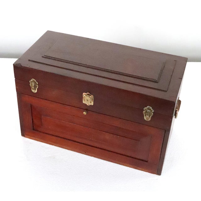 Antique tool chest made of mahogany with a dark finish. It features a top compartment and seven drawers with a pull down...