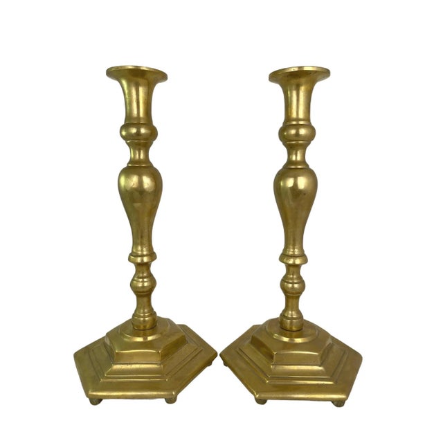 Tall antique solid brass candlesticks. No maker's marks. Minimal age wear.