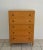 Exquisite Hollywood Regency style wooden tall chest, circa 1950s. This stunning five drawer dresser is designed with...