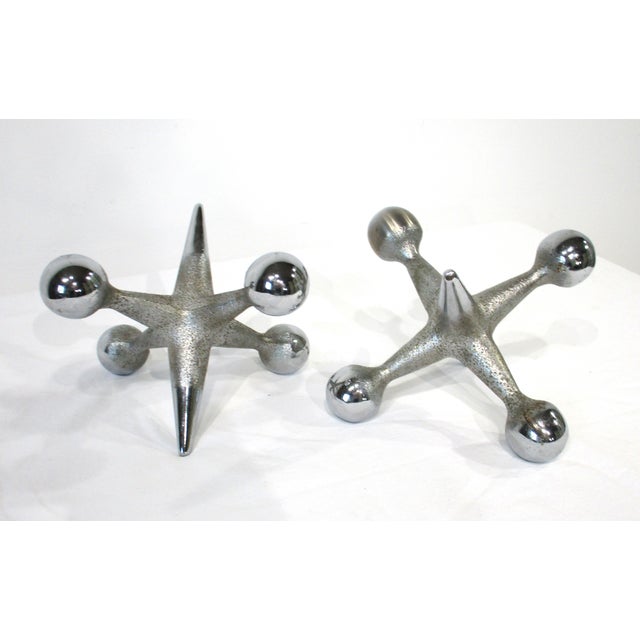 A pair of heavy well -crafted chromed sculptural bookends, paper weights or just sculptures designed by Bill Curry....