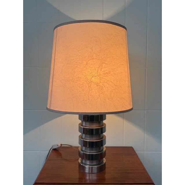 "Space Age" lamp with a chromed steel base and a canvas shade. Dating back to the 1970s. The harmonious design fits...