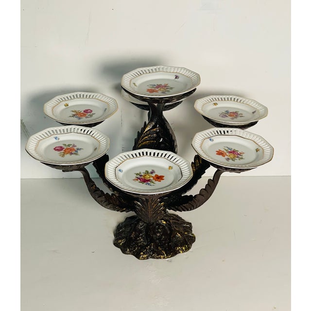 Heavy bronze centerpiece with artichoke leaves in set with dessert reticulated German Shulan plates , floral design.