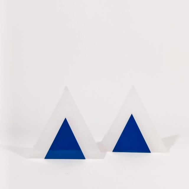 Pair of Italian wall lights with a geometric design by Guzzini, 1970s. Triangular-shaped body formed by two methacrylate...