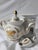 An exceptionally preserved 19th-century French hard-paste porcelain herbal tea teapot and warming nigh light pedestal...