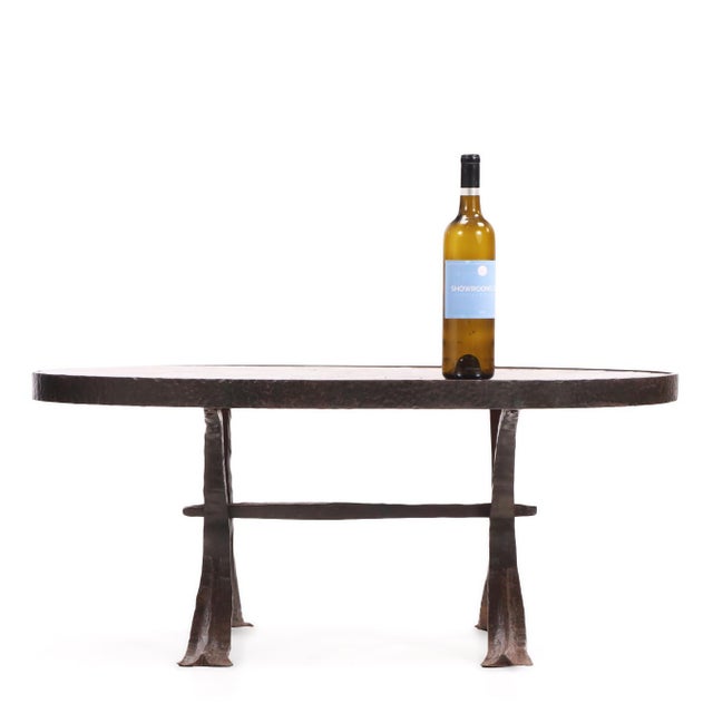 A striking pair of French lava stone tables featuring vibrant glazed and decorated tops mounted within hand-forged wrought...