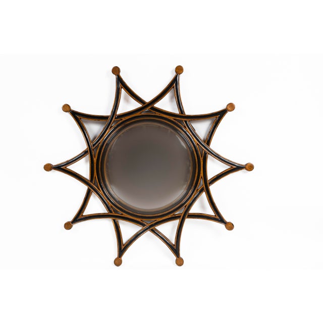 Ebonized and Giltwood Sun Burst Mirror, 20th Century. A regency style interpretation of a sun burst mirror. Lovely...