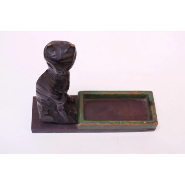 Wooden ebonized cat with dish sculpture mounted to a mahogany plinth. Dish can accommodate keys or smaller objects. Patina...