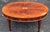 This coffee table features mahogany solids with a yew wood border and a swirl mahogany inset on the top. It also has...