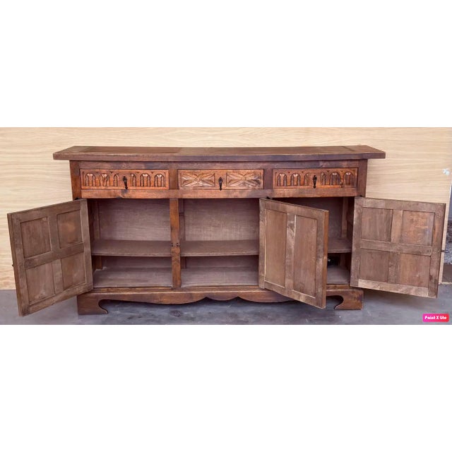 From Northern Spain, constructed of solid walnut, the rectangular top with molded edge atop a conforming case housing two...