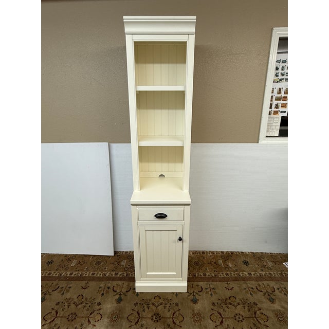 Design Plus Gallery presents the Dutch White Aubrey Narrow Storage Shelf with Cabinet from Pottery Barn. This is a...