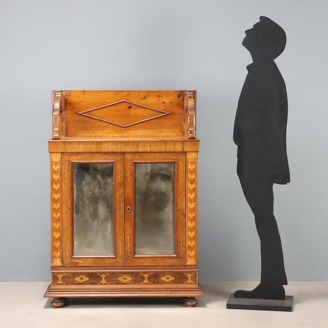 Cherry sideboard created in the 20th century from a 19th-century piece, with modifications and additions. The top has a...