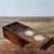 This vintage Chinese rosewood storage box features two inset decorative Qing dynasty silver dollar coins on the front...