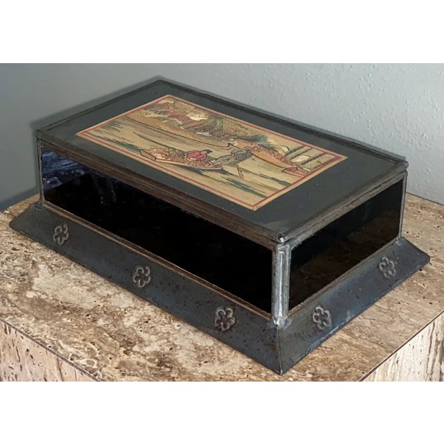 Vintage Mexican hinged tin box featuring black glass sides, decorated tin base, and a great straw mosaic picture on the...