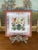This vintage decorative ceramic tile features a colorful hand-painted floral and landscape motif in the traditional French...