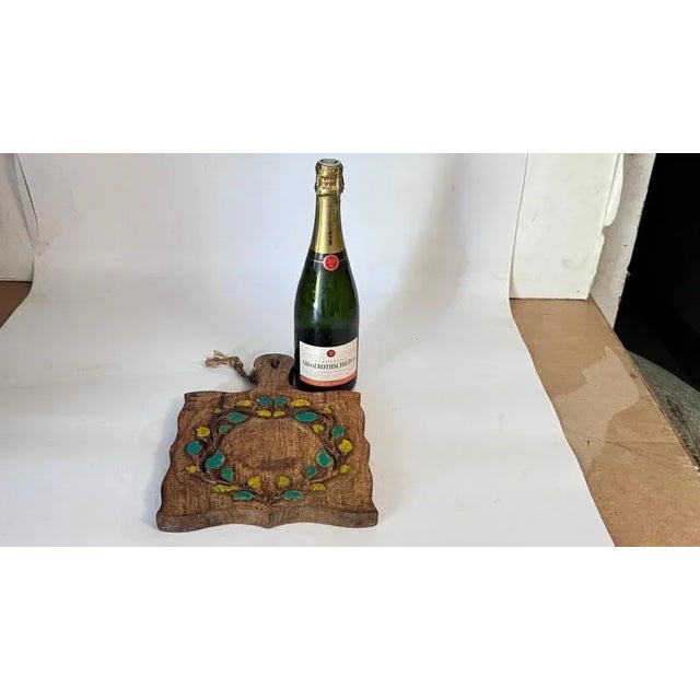This is a vintage French wooden board from the 1960s, featuring a hand-painted floral motif. The decor includes branches...