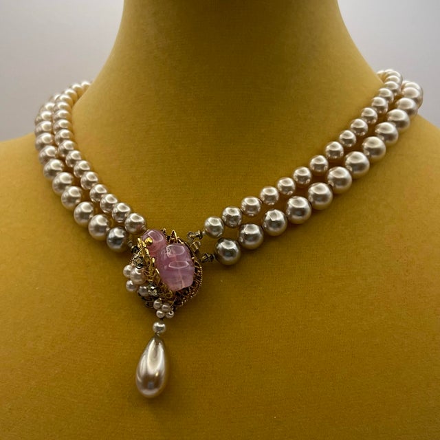 This piece showcases classic Miriam Haskell design, blending faux pearl multi-strand construction with a highly...