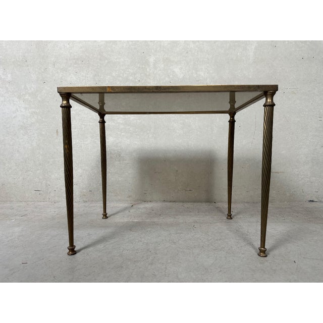 Elegant brass plant table with bronze smoked glass top. Slender turned legs. Very stable. Height: 37.5cm. Width: 47cm....