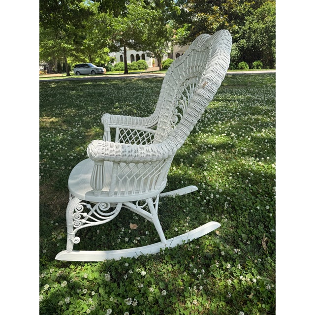 Late Victorian painted wicker rocker with elaborate shell back and scrolling details by Heywood-Wakefield. Some chipping...