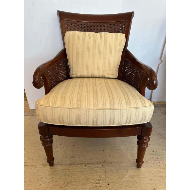 Pair of Mark Hampton mahogany Regency style armchairs having double caned backs, curved arms, turned legs and custom...