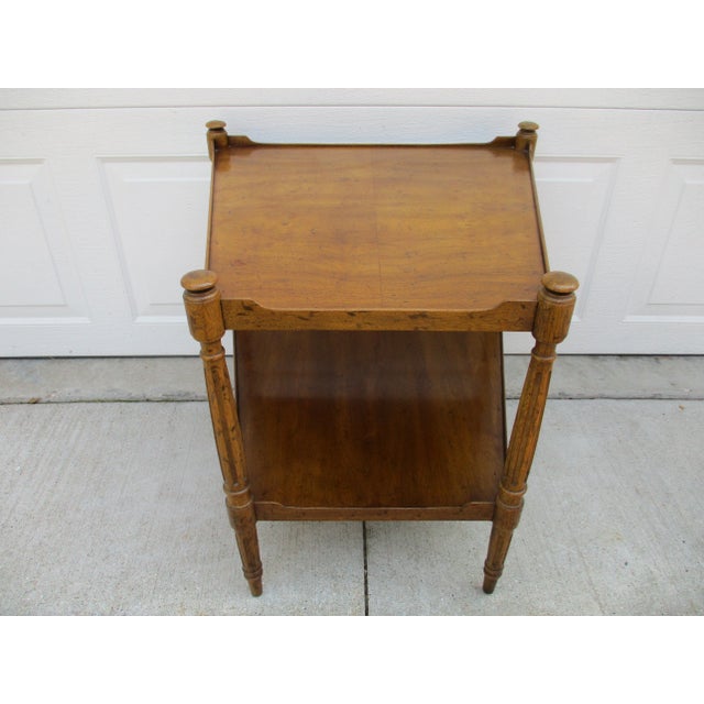 A beautiful wedge-shaped two-tier side table by Heritage. This piece features a tray-like lip around each tier and fluted...