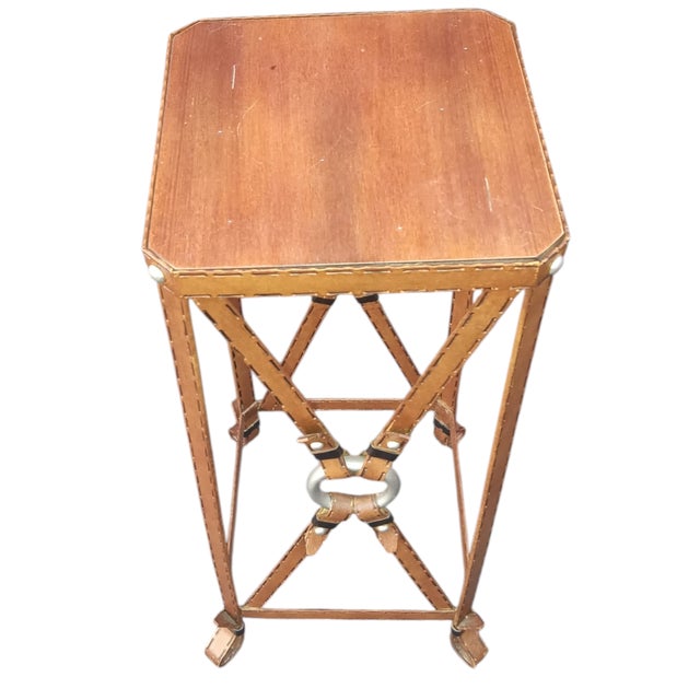 Bring the timeless elegance of the equestrian world into your home with this stunning Adnet Hermès style side table....