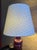 One lampshade with a white linen lining and a woven overlay. Created by Shades of the Midnight Sun.
