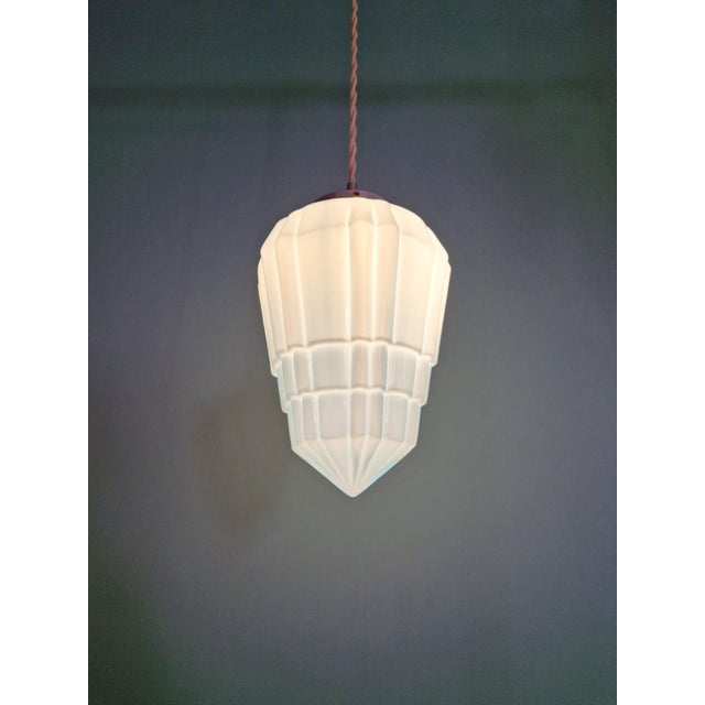 Art Deco pendant light in molded, pressed blue opaline glass with a chromed metal frame, 1920s-30s. The pendant has been...
